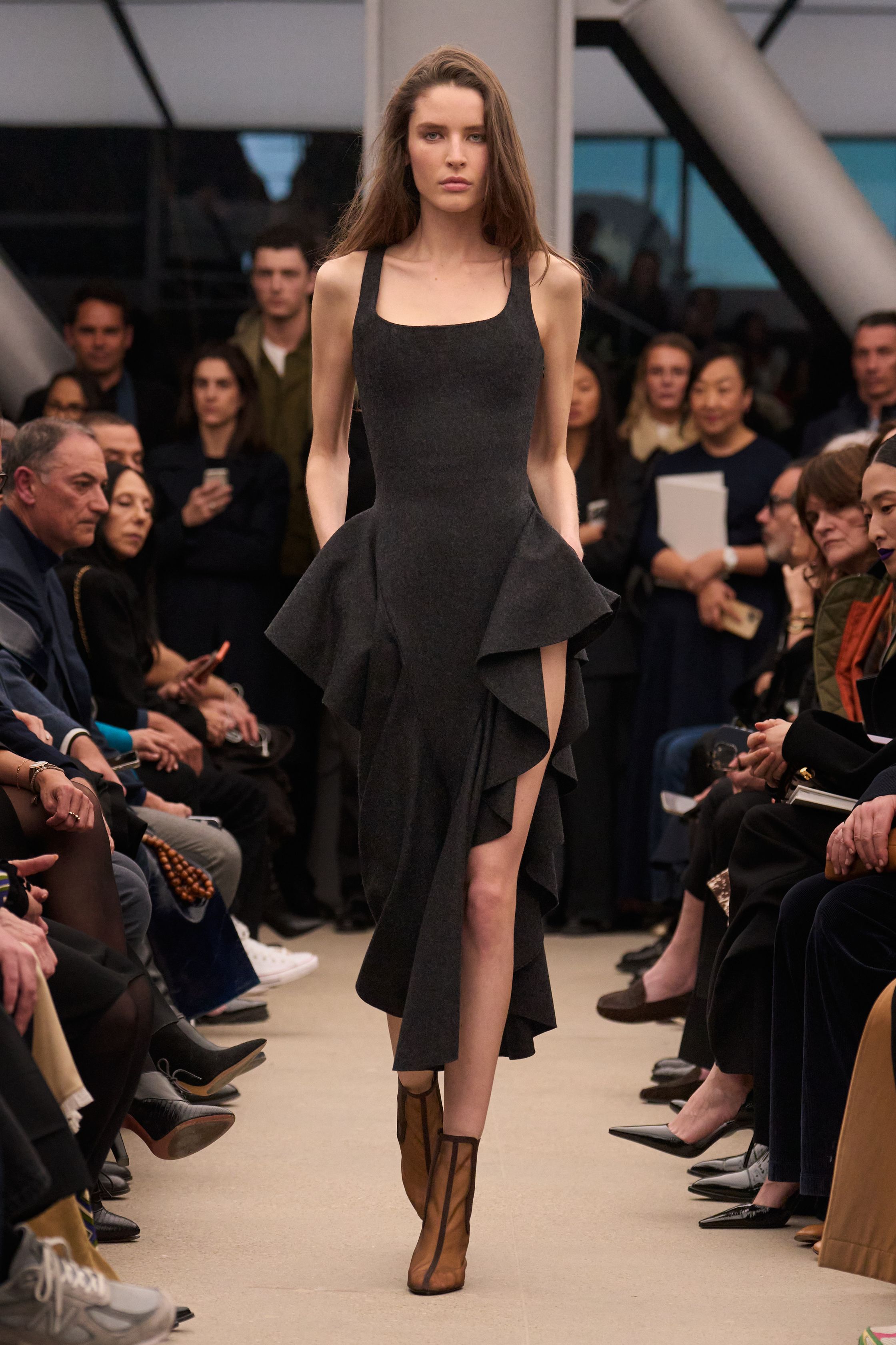 Alaïa继续以雕塑般的女性身体线条为核心，呈现极致精准的剪裁与材质张力。贴身针织长裙、立体外套与收腰大衣展现品牌标志性的曲线美学，整体色调以米色、酒红与深棕为主，营造出沉稳而性感的高级氛围。轮廓简洁却充满力量，既强调女性身体曲线，又通过结构性裁剪赋予服装雕塑般的建筑感，让极简主义与性感力量达到平衡-顽石频道趋势研究
